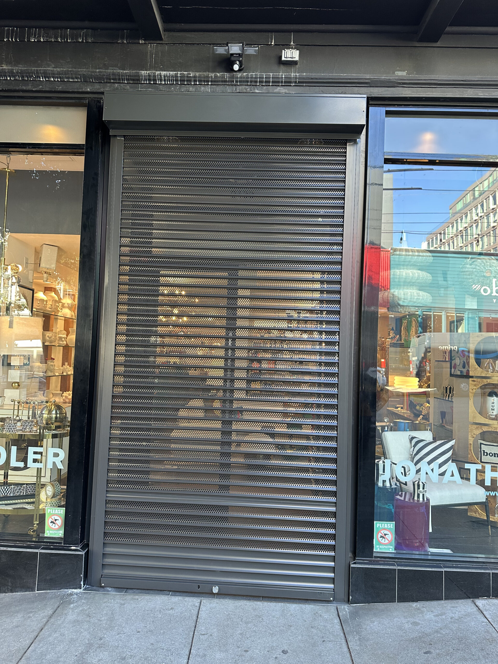 Exterior perforated rolling shutters on a San Francisco, California storefront
