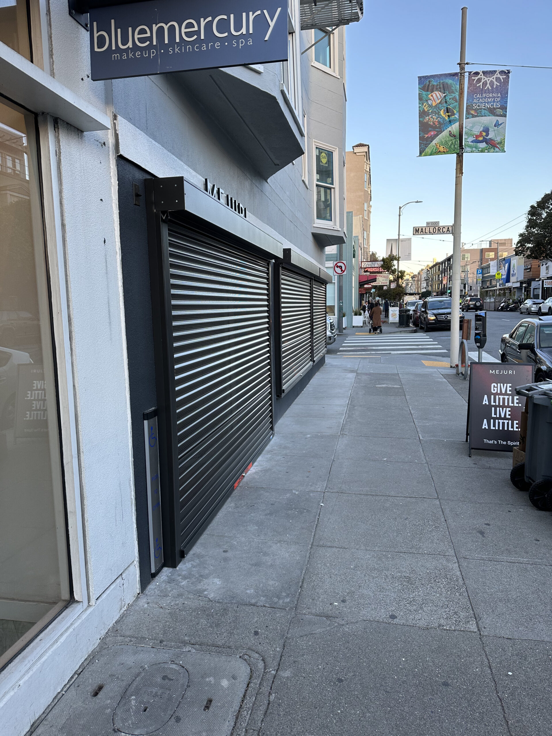 Roll-down perforated security shutters on a San Francisco, California business exterior