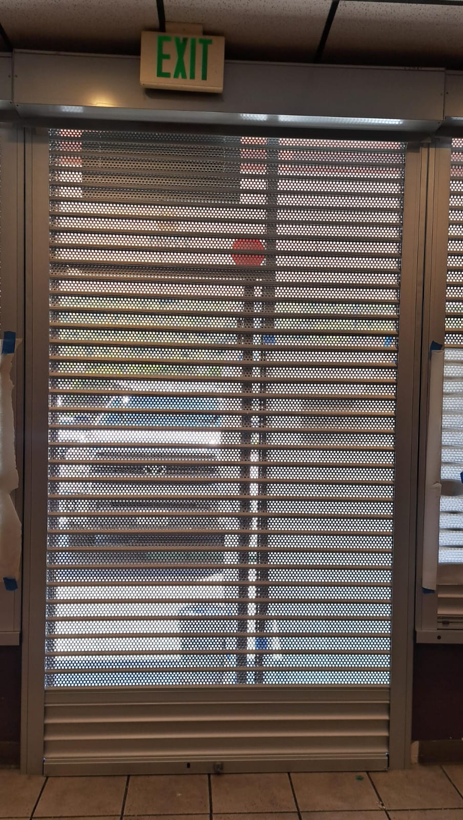 Perforated rolling security shutters installed inside a Santa Clarita, California business