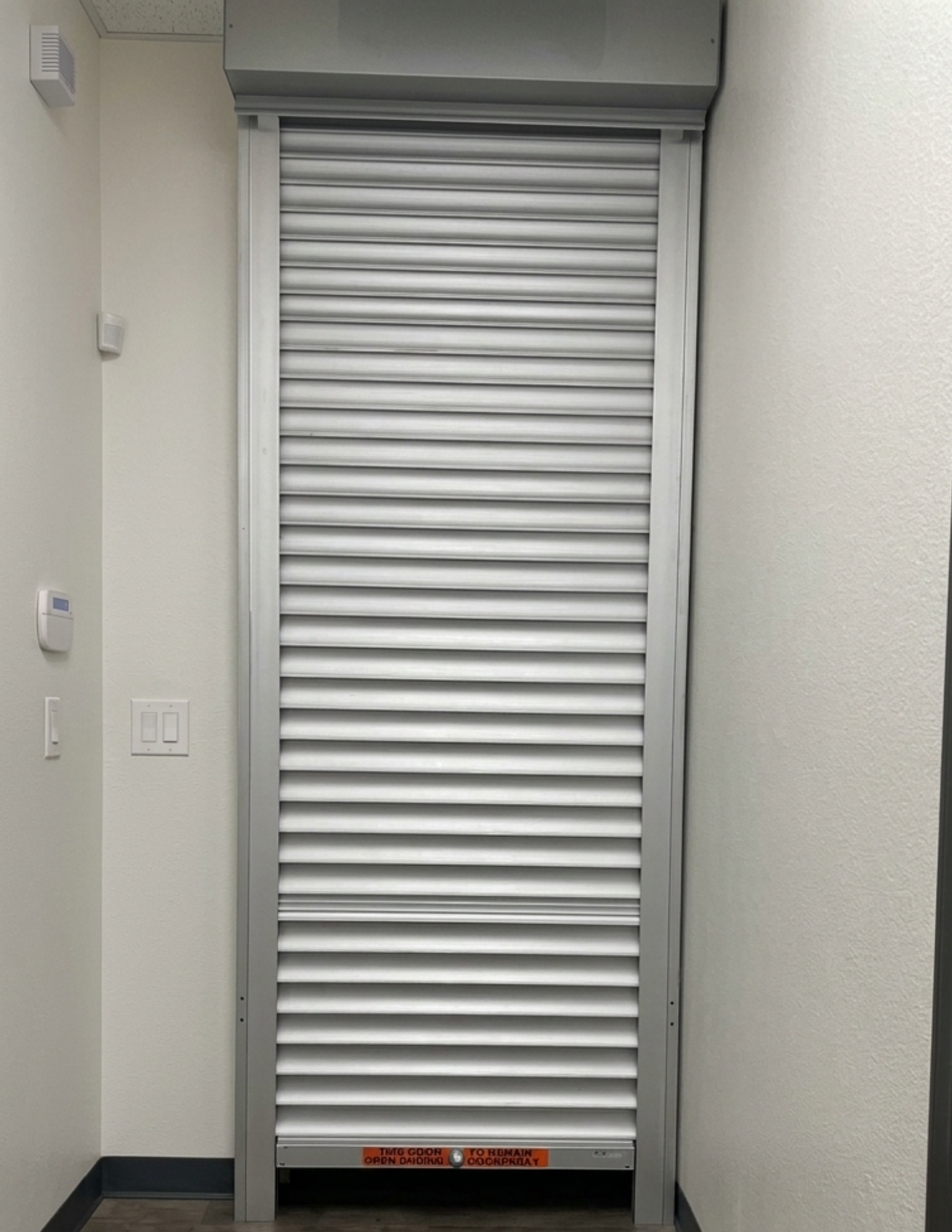 Roll-down security shutters installed inside a Tracy, California commercial business