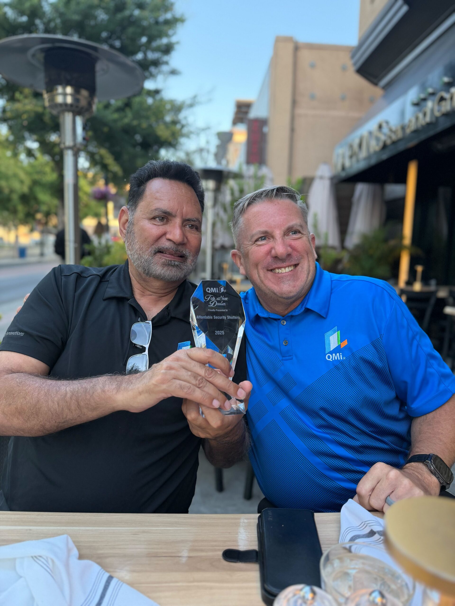 Jessie Bajwa receiving the QMi Top New Dealer award in 2025